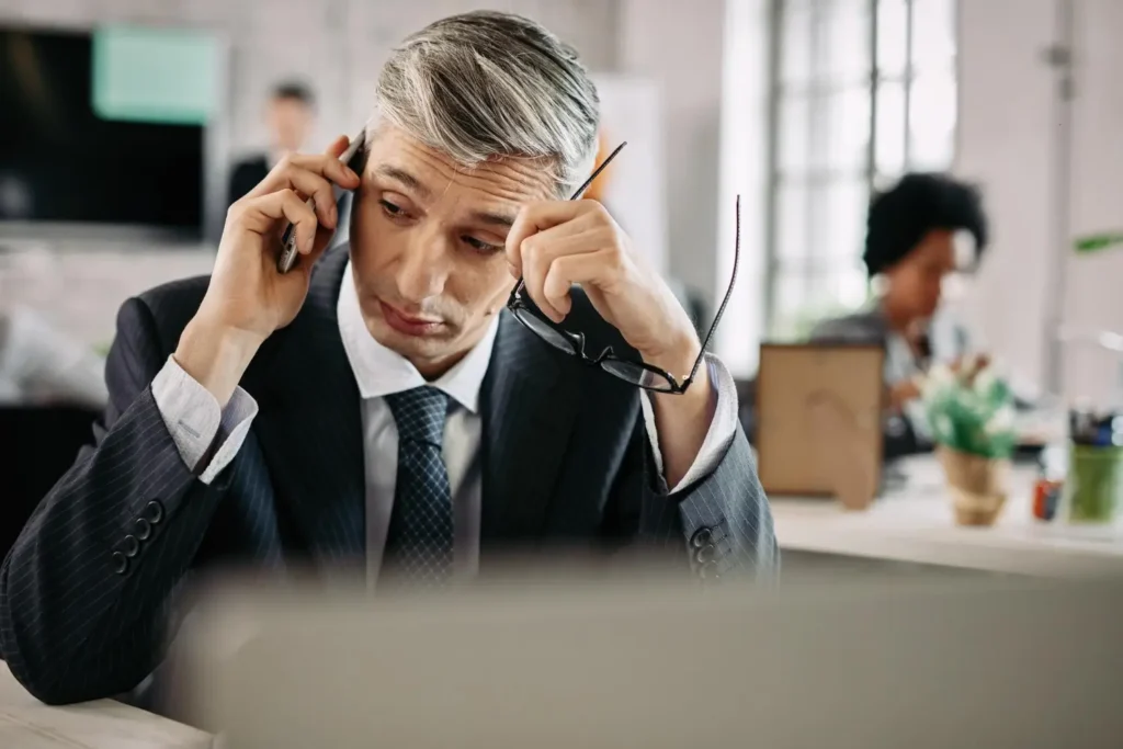 Serious person talking on the phone with a suit